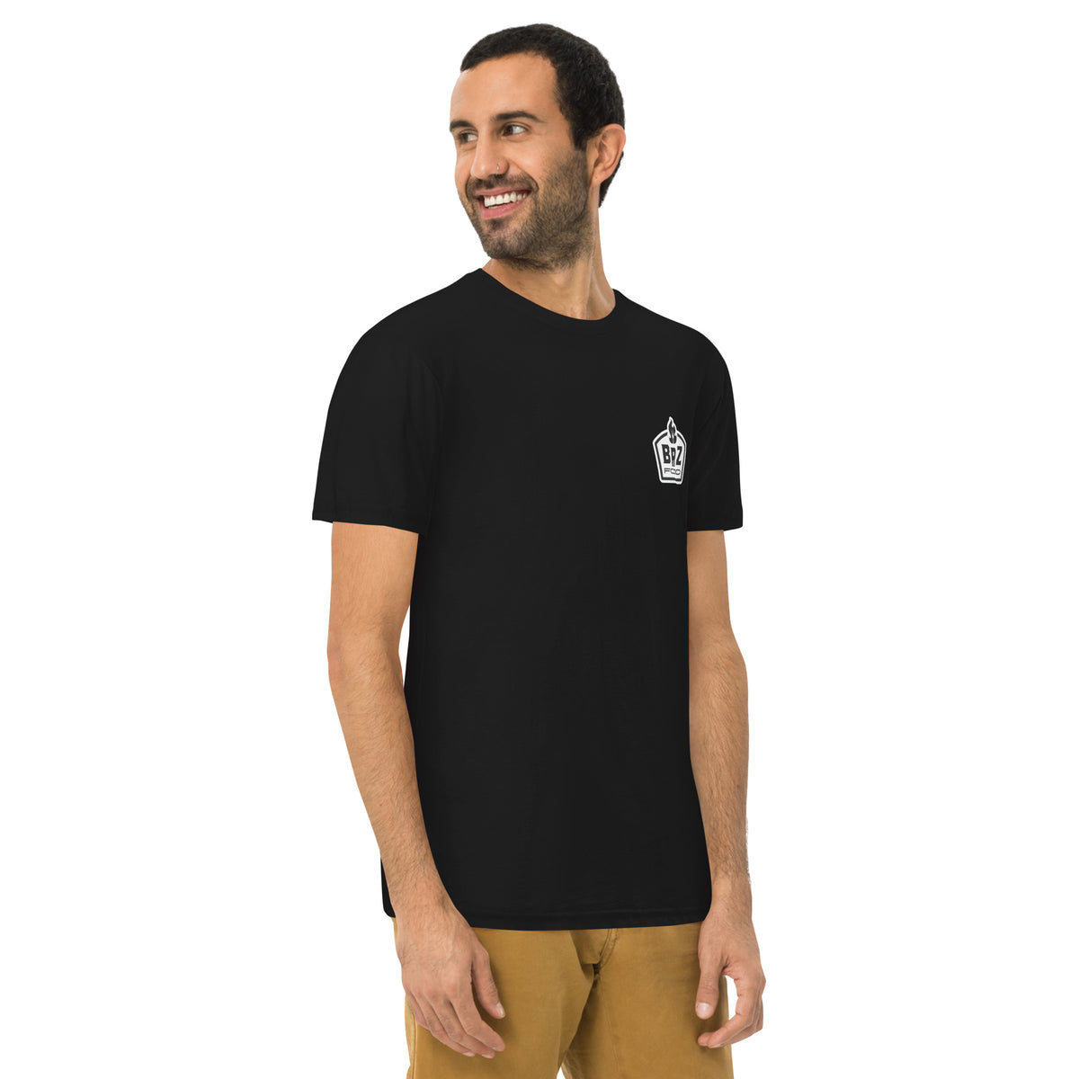 Man wearing the black tee from the front, the small chest crest just visible